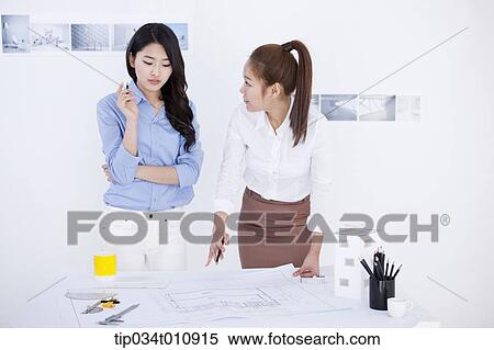 Stock Photography - two interior designers working on a project. Fotosearch