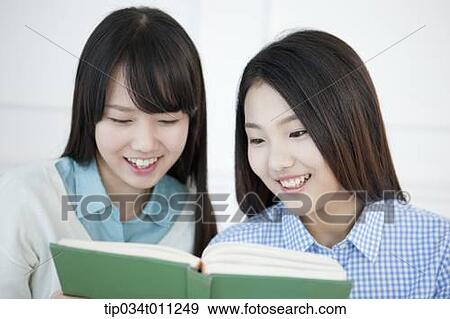 two ladies reading a book together View Large Photo Image Stock Photo - two ladies reading a book together. Fotosearch