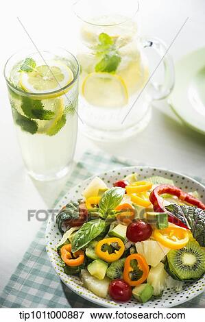 Stock Photo - a bowl of vegetables and glasses of water. Fotosearch