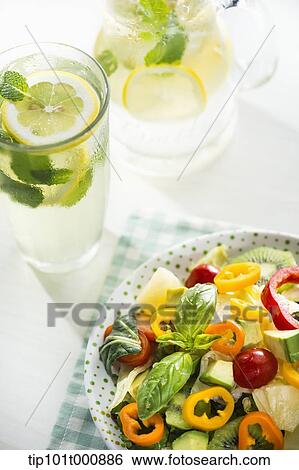 a bowl of vegetables and glasses of water View Large Photo Image Stock Photograph - a bowl of vegetables and glasses of water. Fotosearch