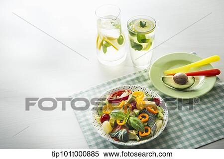 Stock Photography - a bowl of vegetables and glasses of water. Fotosearch