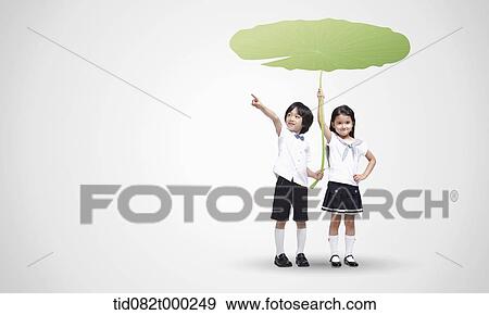 a boy and a girl holding lotus leaf View Large Photo Image Stock Photo - a boy and a girl holding lotus leaf. Fotosearch