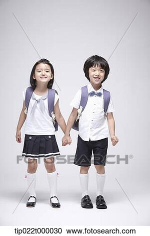 a boy and a girl wearing school bags holding hands View Large Photo Image Stock Image - a boy and a girl wearing school bags holding hands. Fotosearch