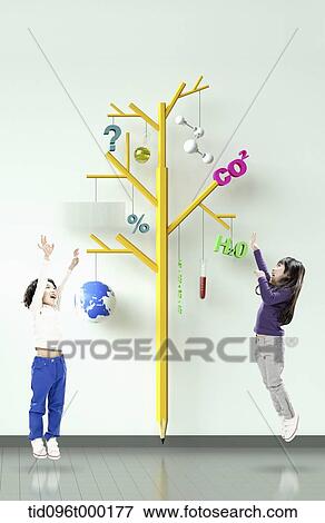 Stock Photo - a boy and a girl with a tree with education icons. Fotosearch