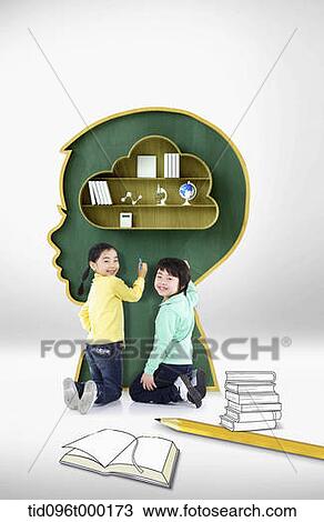 a boy and a girl writing something on black board with shape of human head View Large Photo Image Stock Image - a boy and a girl writing something on black board with shape of human head. Fotosearch