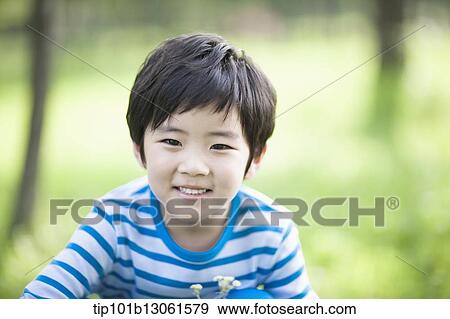 Stock Photo - a boy exploring the nature. Fotosearch