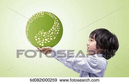 a boy holding a ball with arrow design View Large Photo Image Stock Photo - a boy holding a ball with arrow design . Fotosearch