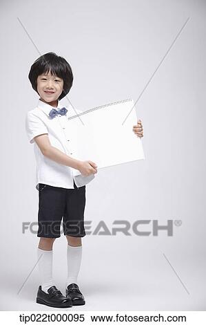 a boy holding a blank sketch book View Large Photo Image Stock Photography - a boy holding a blank sketch book. Fotosearch