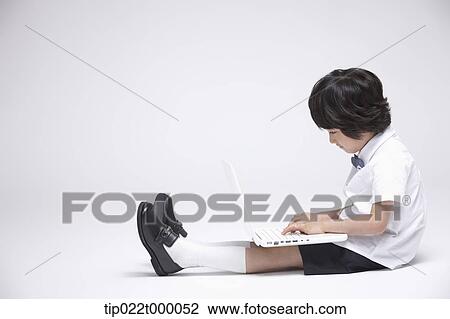 a boy in school uniform using a laptop View Large Photo Image Stock Image - a boy in school uniform using a laptop . Fotosearch