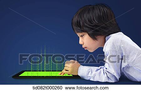 a boy looking at a tablet PC View Large Photo Image Stock Image - a boy looking at a tablet PC . Fotosearch