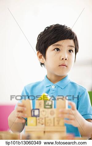 a boy playing with wood cubes with icons View Large Photo Image Stock Photo - a boy playing with wood cubes with icons. Fotosearch