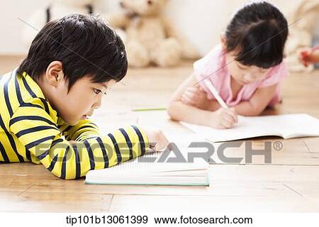 Stock Photo - a boy reading a book. Fotosearch