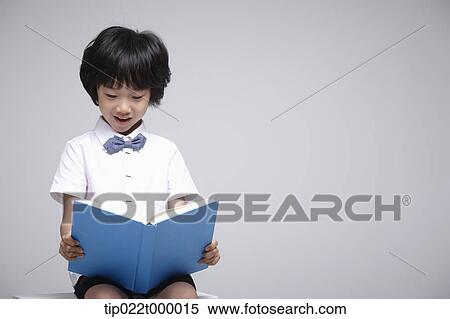 a boy reading a book View Large Photo Image Stock Photography - a boy reading a book. Fotosearch