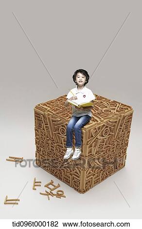 a boy sitting on a cube with Hangul View Large Photo Image Stock Image - a boy sitting on a cube with Hangul. Fotosearch