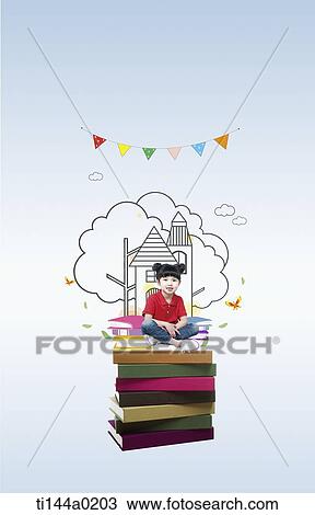 Stock Image - a boy sitting on a pile of illustrated books. Fotosearch