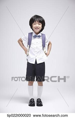 a boy wearing a school bag standing in white background View Large Photo Image Stock Image - a boy wearing a school bag standing in white background. Fotosearch