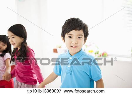 Stock Photo - a boy with a blue shirt. Fotosearch