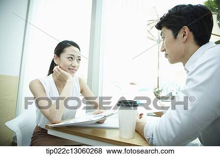 a business man and a business woman at a coffee shop View Large Photo Image Stock Photo - a business man and a business woman at a coffee shop. Fotosearch