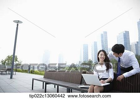 a business man and a business woman working together View Large Photo Image Stock Image - a business man and a business woman working together. Fotosearch