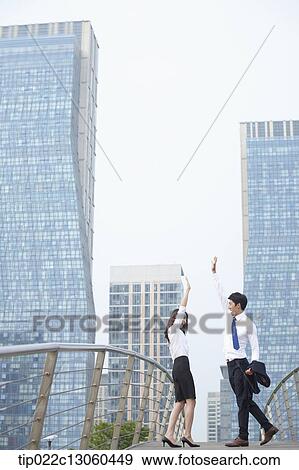 Stock Photo - a business man and a business woman being excited. Fotosearch