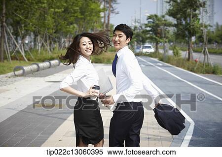 a business man and a business woman walking on the street View Large Photo Image Stock Photography - a business man and a business woman walking on the street. Fotosearch