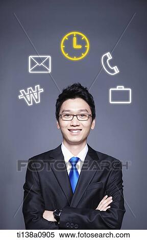 Stock Photography - a business man with icons around his head. Fotosearch
