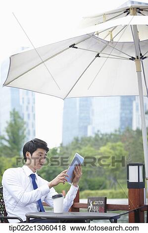 a business man working with a tablet View Large Photo Image Stock Photo - a business man working with a tablet. Fotosearch