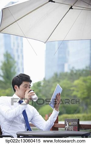 a business man working with a tablet View Large Photo Image Stock Photography - a business man working with a tablet. Fotosearch