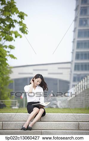 a business woman sitting outside and working View Large Photo Image Stock Photo - a business woman sitting outside and working. Fotosearch