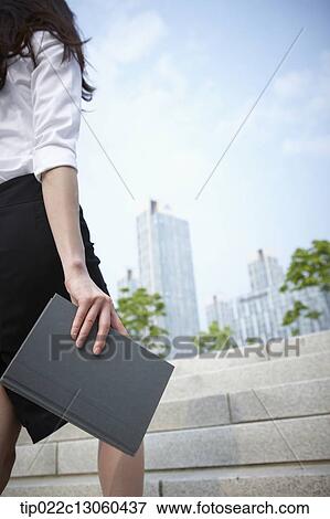 Stock Photo - a business woman walking up stairs. Fotosearch