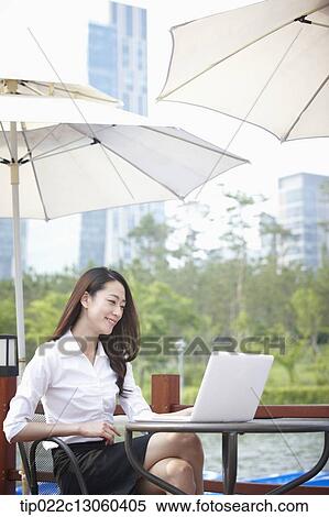a business woman working while having a coffee View Large Photo Image Stock Photography - a business woman working while having a coffee. Fotosearch