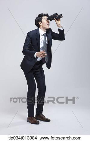 a businessman looking at something with binocular View Large Photo Image Picture - a businessman looking at something with binocular. Fotosearch