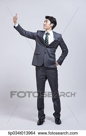Picture - a businessman waving his hand. Fotosearch