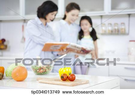 a child reading a book with two women in the kitchen View Large Photo Image Stock Photo - a child reading a book with two women in the kitchen. Fotosearch