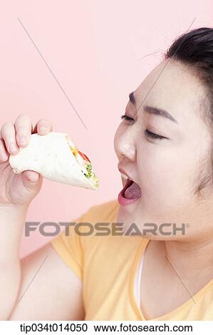 a chubby woman about to eat sandwich wrap View Large Photo Image Stock Image - a chubby woman about to eat sandwich wrap. Fotosearch