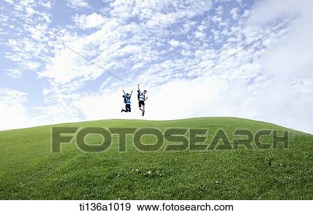 a couple hiking on a grass field View Large Photo Image Stock Photo - a couple hiking on a grass field. Fotosearch