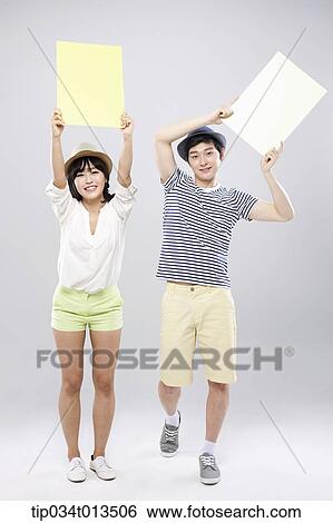a couple holding empty boards View Large Photo Image Stock Photograph - a couple holding empty boards . Fotosearch