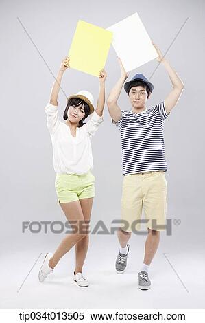Stock Photography - a couple holding empty boards . Fotosearch