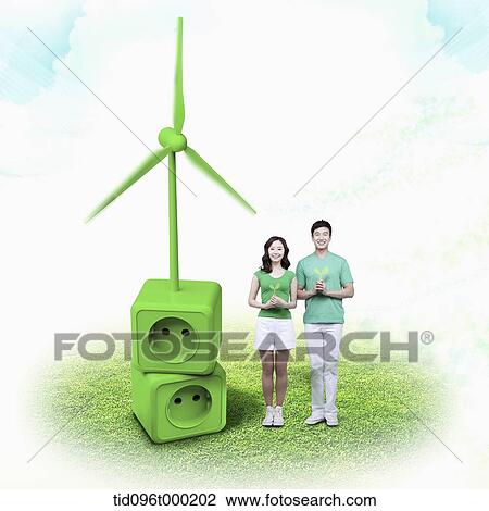 Stock Image - a couple standing next to a green outlet . Fotosearch