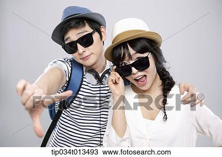 a couple with sunglasses posing together View Large Photo Image Stock Image - a couple with sunglasses posing together. Fotosearch