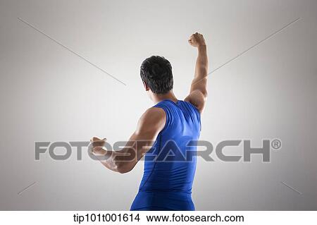 a fit man in blue shirt posing with hands View Large Photo Image Picture - a fit man in blue shirt posing with hands. Fotosearch