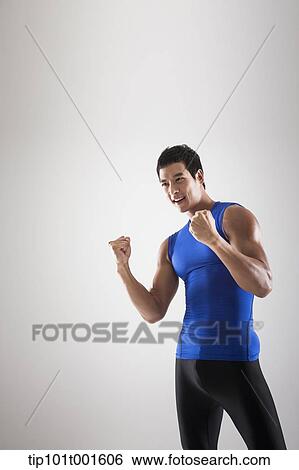 a fit man in blue shirt posing with hands View Large Photo Image Stock Photograph - a fit man in blue shirt posing with hands. Fotosearch