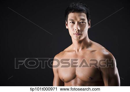 a fit man posing in black background View Large Photo Image Stock Image - a fit man posing in black background. Fotosearch