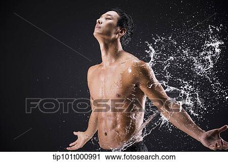 a fit man posing in black background with water splash View Large Photo Image Stock Image - a fit man posing in black background with water splash. Fotosearch