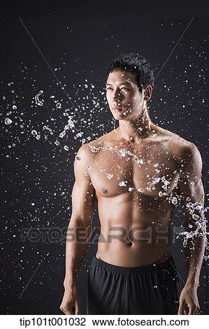 a fit man posing in black background with water splash View Large Photo Image Stock Image - a fit man posing in black background with water splash. Fotosearch