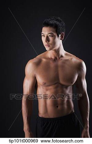 a fit man posing in black background View Large Photo Image Stock Photo - a fit man posing in black background. Fotosearch