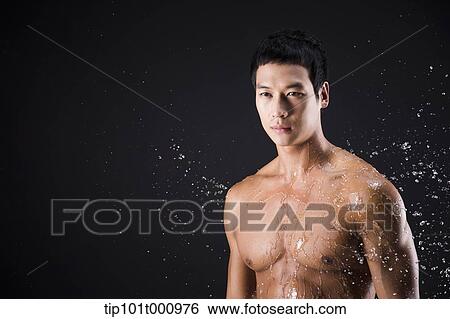a fit man posing in black background with water splash View Large Photo Image Stock Photograph - a fit man posing in black background with water splash. Fotosearch