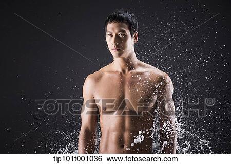 a fit man posing in black background with water splash View Large Photo Image Stock Photograph - a fit man posing in black background with water splash. Fotosearch