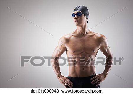 Stock Image - a fit man with swimming goggle and hat posing. Fotosearch