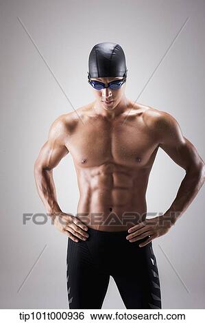 a fit man with swimming goggle and hat posing View Large Photo Image Stock Photograph - a fit man with swimming goggle and hat posing. Fotosearch
